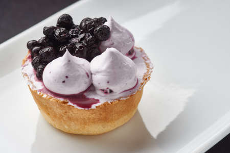 Beautiful sugar cream Cupcake dessert with blackberryの写真素材