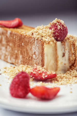 Beautiful cake dessert with cream and fresh berry on white backgroundの写真素材