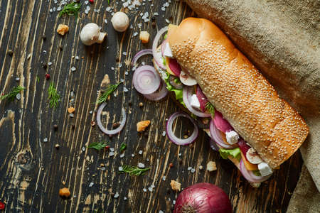 Rustic sandwich with set of ingridients on an old wooden boardの写真素材