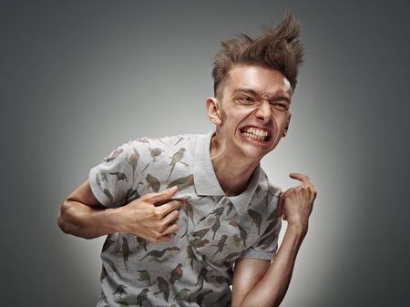 Emotional portrait of a teenager on a gray backgroundの写真素材