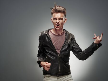 Emotional portrait of a teenager dancing on a gray backgroundの写真素材
