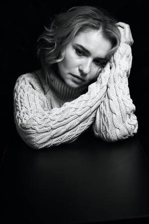 Black and white portrait of a beautiful woman on a dark backgroundの写真素材