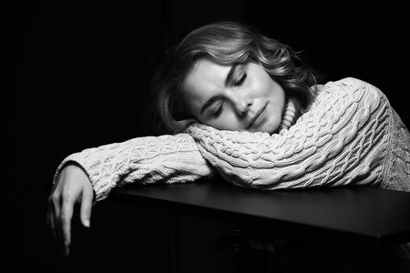 Black and white portrait of a beautiful woman on a dark background