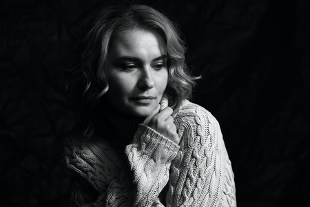 Black and white portrait of a beautiful woman on a dark backgroundの写真素材