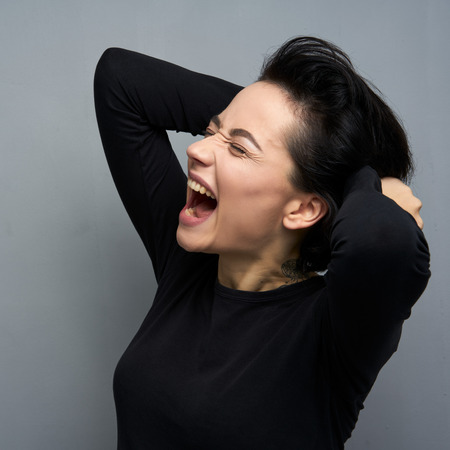 Emotional portrait of female with cheerful expression, dressed in casual clothes,の写真素材