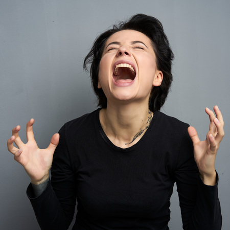Emotional portrait of female with cheerful expression, dressed in casual clothes,の写真素材