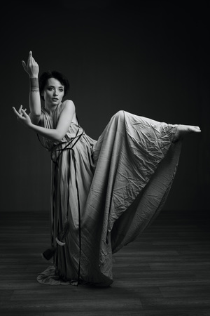 black and white dancing woman studio portrait on a dark backgroundの写真素材
