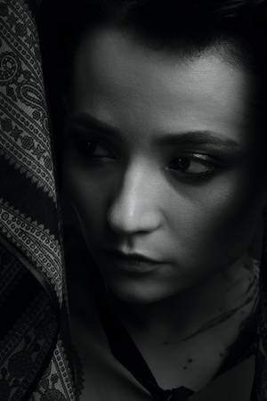 Black and white studio portrait of a woman on a dark backgroundの写真素材