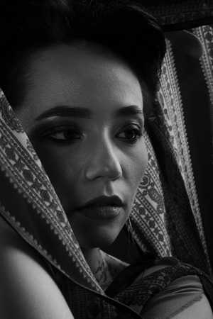 Black and white studio portrait of a woman on a dark backgroundの写真素材
