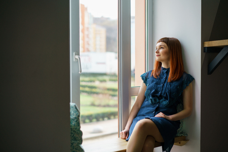 Pretty woman sitting in a cafe with cup of teaの写真素材
