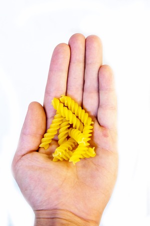 spiral yellow pasta on the white backgraundの写真素材