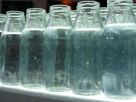 Closeup of Empty Milk Bottles -- filled with waterの写真素材