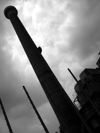 Deserted Factory -- with a towering chimney, seen in silhouetteの写真素材