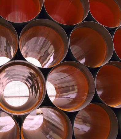 Large Drainage Pipes -- made out of orange PVC, with metal caps