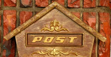 Traditional Mailbox -- made from brass in the shape of a houseの写真素材