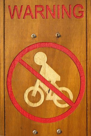 No Biking -- a warning sign carved on a wooden boardの写真素材