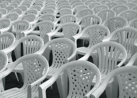 Sea of Chairs -- empty white plastic chairs lined up for a performanceの写真素材