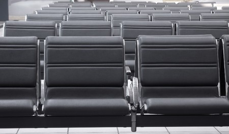 Waiting area with empty seats in a modern train stationの写真素材