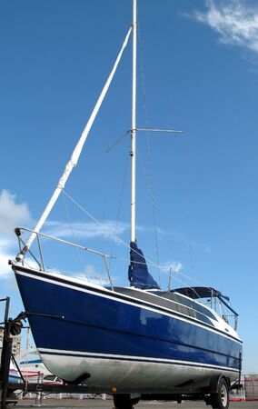 A blue sailing yacht on dry landの写真素材