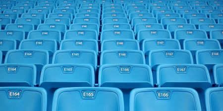 Hundreds of blue folding chairs in large stadiumの写真素材