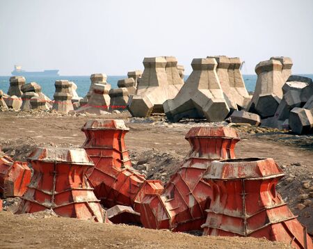 Large concrete tetrapods are placed on the sea shoreの写真素材