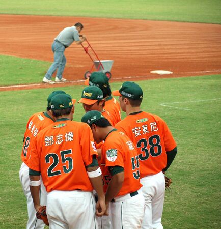 PINGTUNG, TAIWAN, APRIL 8: President Lions players who face the Lamigo Monkeys in a Pro Baseball League game discuss their strategy. The Lions won 2:0 on April 8, 2012 in Pingtung.のeditorial素材