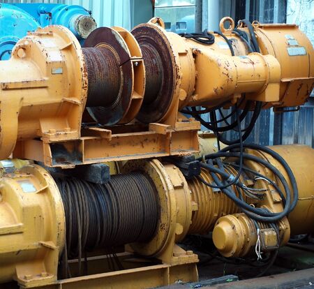 Large industrial winches are used to haul in steel cablesの写真素材