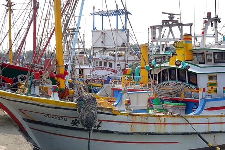 KAOHSIUNG, TAIWAN -- MARCH 14, 2014: Traditional Chinese wooden fishing boats seek shelter at Zi Guan Port.のeditorial素材
