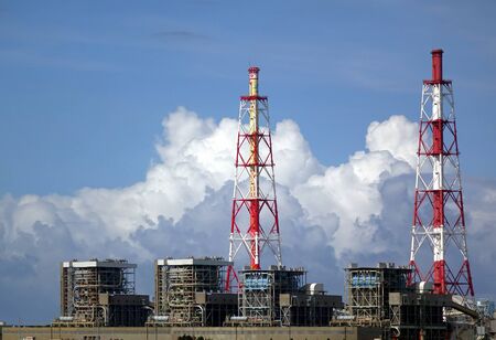 A large thermal power plant with beautiful cloud formationsの写真素材