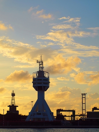 The control tower guarding the entrance to Kaohsiung port at duskの写真素材