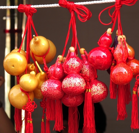 KAOHSIUNG, TAIWAN -- FEBRUARY 19, 2015: An outdoor vendor sells small dried gourds that are painted and varnished and decorated with Buddhist scriptures.のeditorial素材