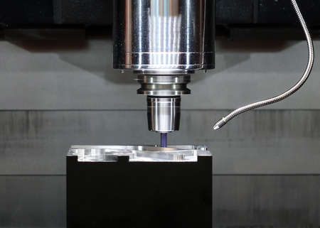 A high precision automated routing tool in operation on a piece of metalの写真素材