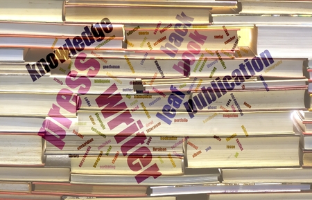 A wordcloud about books, printing, publications against a blurred background of booksの写真素材