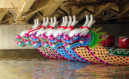 KAOHSIUNG, TAIWAN -- MAY 21, 2017: Traditional dragon boats are anchored under a bridge on the Love River in preparation for the upcoming Dragon Boat Festival.のeditorial素材