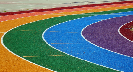 Running tracks in several bright colors with white lane markingsの写真素材