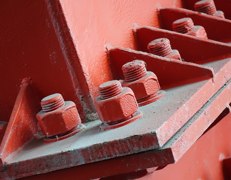 Heavy duty bolts and nuts hold a girder in placeの写真素材