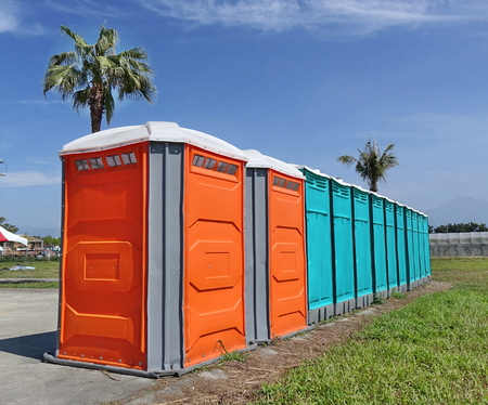 A row of portable toilets set up at a public eventの写真素材