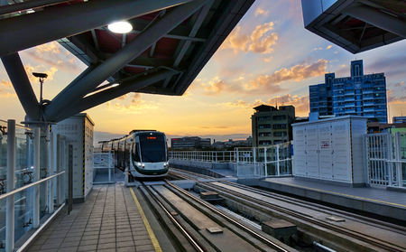 KAOHSIUNG, TAIWAN -- MARCH 2, 2018: A train of the new light rail system pulls into the Love Pier station at sunset time.のeditorial素材