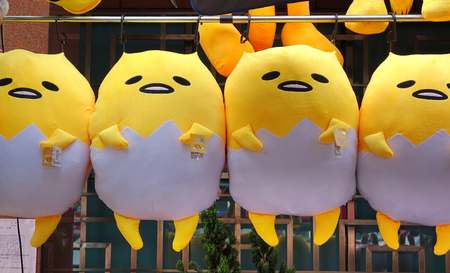 KAOHSIUNG, TAIWAN -- FEBRUARY 17, 2018: A street vendor sells large dolls based on the Japanese cartoon character Gudetama.のeditorial素材