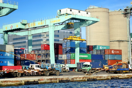 KAOHSIUNG, TAIWAN -- MAY 26, 2018: A shipping container is being loaded in the busy port of Kaohsiung, a major trading hub for Taiwan.のeditorial素材