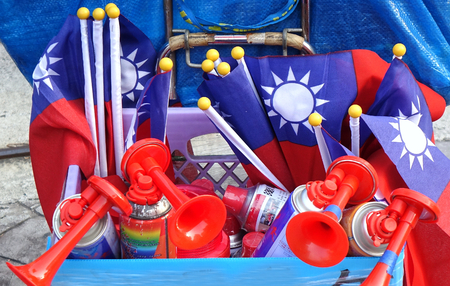 KAOHSIUNG, TAIWAN -- NOVEMBER 10, 2018: A vendor sells air horns and national flags at an election rally.のeditorial素材