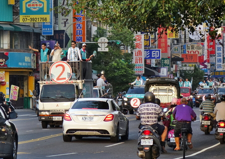 KAOHSIUNG, TAIWAN -- NOVEMBER 23, 2018: A motorcade in support in support of Kaohsiung mayor candidate Chen Chi-Mai from the DPP drives through dense traffic. Chen Chi-Mai lost the election.のeditorial素材