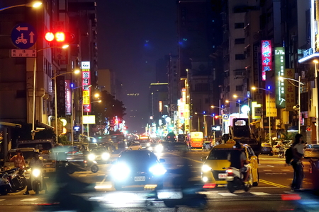 KAOHSIUNG, TAIWAN -- DECEMBER 1, 2018: Busy traffic during evening rush hour in downtown Kaohsiung. The image features motion blur.のeditorial素材