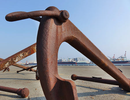 Large rusty buoy anchor encrusted with barnaclesの写真素材