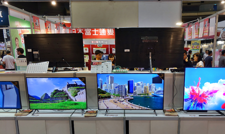 KAOHSIUNG, TAIWAN -- APRIL 5, 2019: Visitors at a sales and promotional fair for electric household appliances look at flat screen TVs.のeditorial素材
