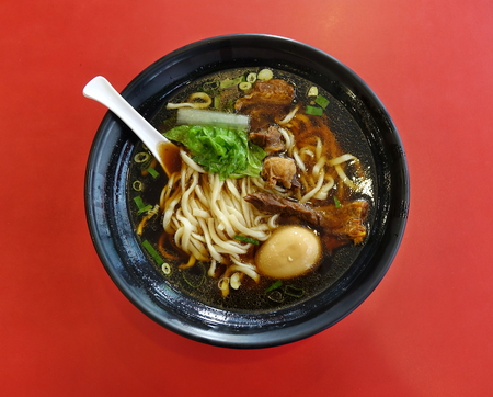Braised beef in broth with noodles and chives is a popular dish in Taiwanの写真素材