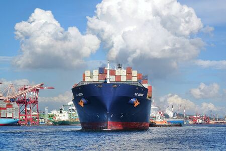 KAOHSIUNG, TAIWAN -- JUNE 2, 2019: A large container ship is getting ready to leave Kaohsiung Port.