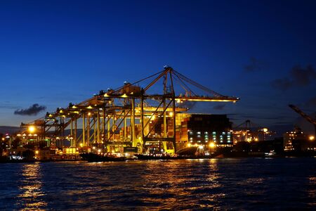 KAOHSIUNG, TAIWAN -- JUNE 2, 2019: A view of the busy Kaohsiung container shipment port at evening...