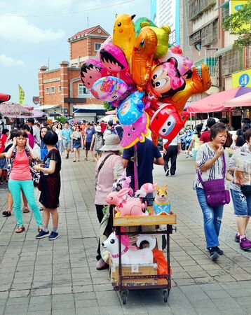 KAOHSIUNG, TAIWAN -- JUNE 27, 2019: A street vendor sells balloons on the main tourist street on Chijin Island.のeditorial素材