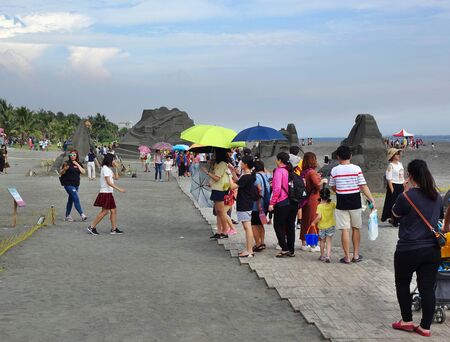 KAOHSIUNG, TAIWAN -- JULY 27, 2019: Tourists at the Black Sand Beach festival on Chijin Island.のeditorial素材